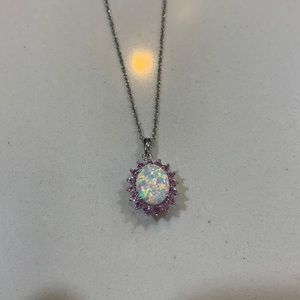 So pretty opal pendant surrounded by pink sapphires.